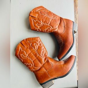 Tan mid-calf cowboy boots.